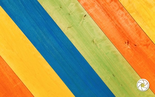 Closeup Multicolored Pattern of Yellow, Blue, Green and Orange Wooden Planks in Diagonal Position for Background.